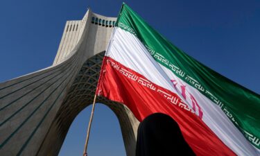 An Iranian flag is carried under the Azadi (Freedom) monument tower during the annual rally commemorating Iran's 1979 Islamic Revolution in Tehran in February.