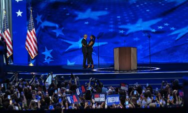 Former President Barack Obama and Michelle Obama embrace on stage on August 20