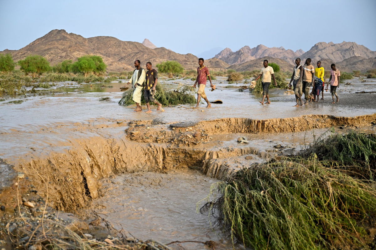 <i>AFP/Getty Images via CNN Newsource</i><br/>Damaged trucks buried in the mud after the collapse of the Arba'at Dam in Sudan following heavy rains and torrential floods on August 25