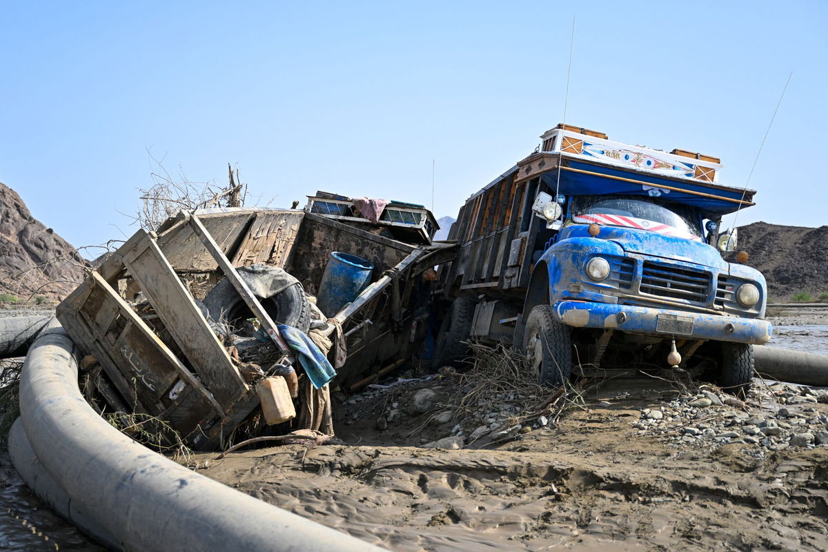 <i>AFP/Getty Images via CNN Newsource</i><br/>Damaged trucks buried in the mud after the collapse of the Arbaat Dam