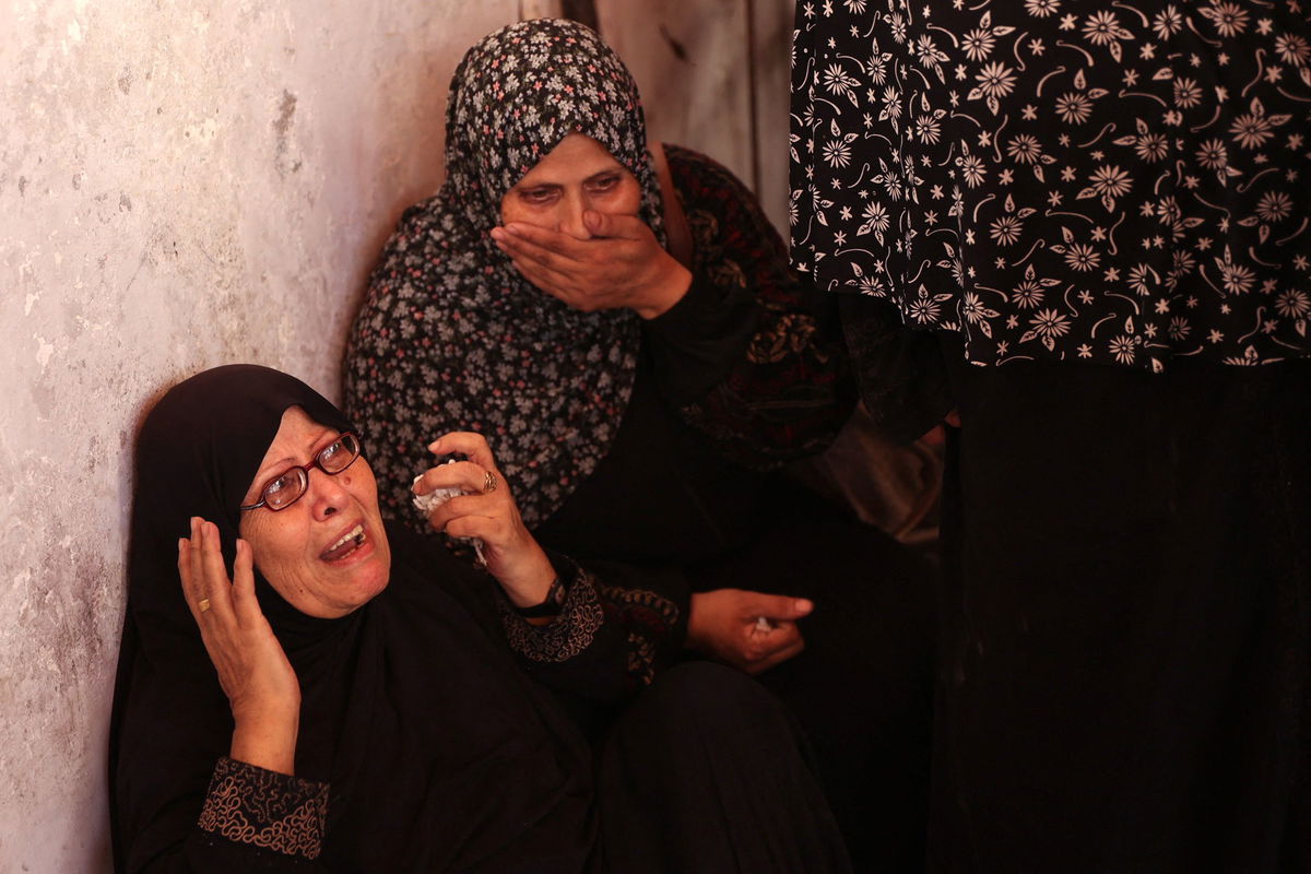 <i>Omar Al-Qattaa/AFP/Getty Images via CNN Newsource</i><br/>Palestinians inspect the damage at the site of the Israeli strike.