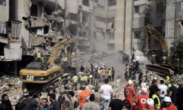 Emergency workers use excavators to clear the rubble at the site of the Israeli strike in Beirut's southern suburbs on September 20.