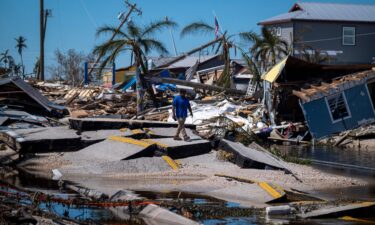 A man walks over Pine Island Road in Matlacha