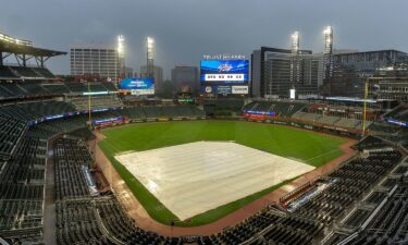 A tarp covers the infield as rain comes down at Truist Park in Atlanta after both September 25 and 26 New York Mets-Atlanta Braves games were postponed due to inclement weather.