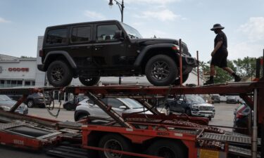 Jeep vehicles are delivered to a dealership on June 20 in Chicago.