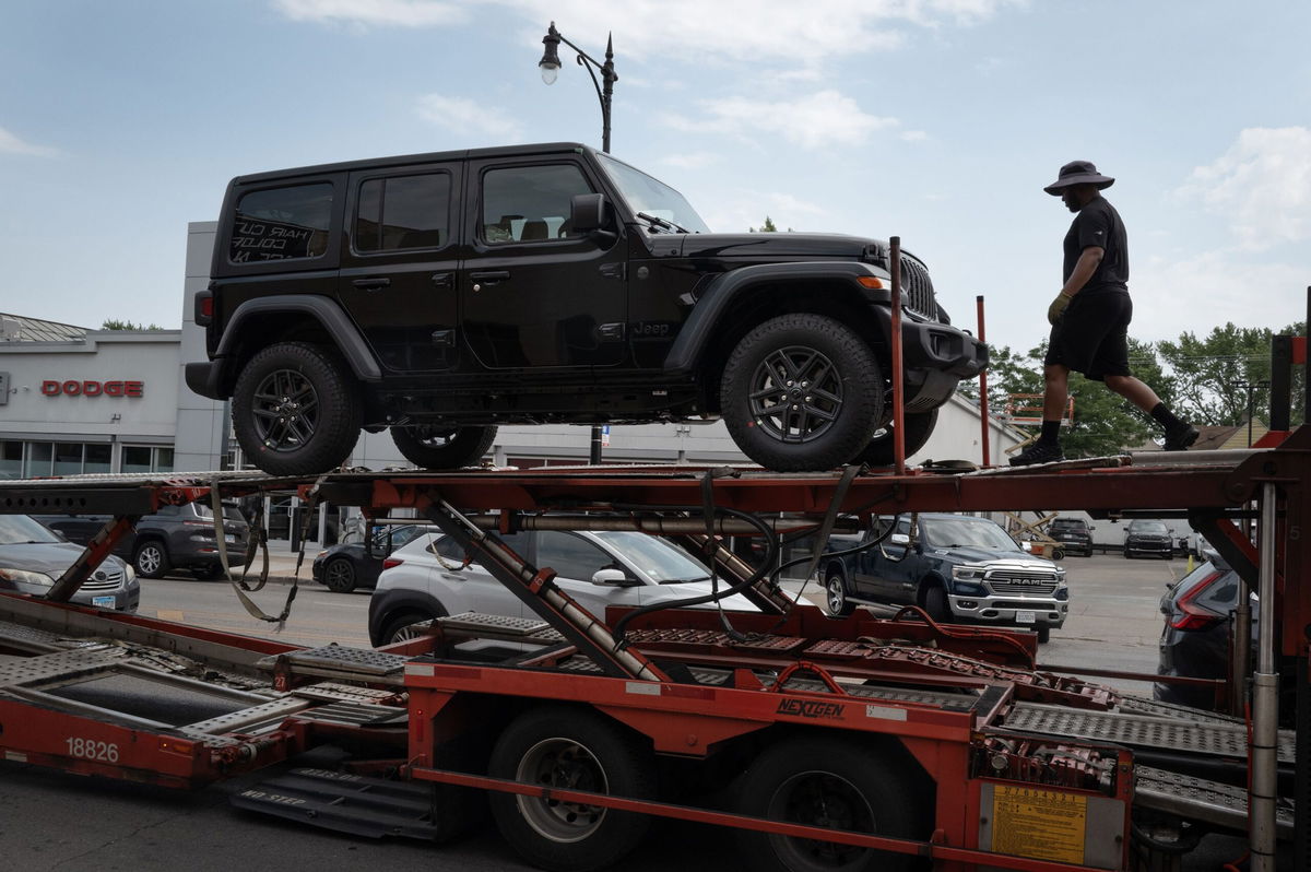 <i>Scott Olson/Getty Images/File via CNN Newsource</i><br/>Jeep vehicles are delivered to a dealership on June 20 in Chicago.