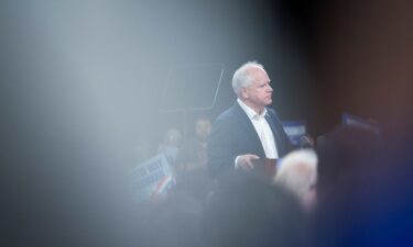 Attendees listen to Walz speak at a campaign rally in Erie