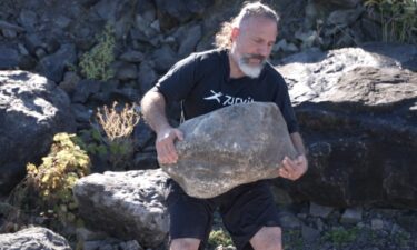 This stone in Johnson's hands weighs roughly 200 pounds.