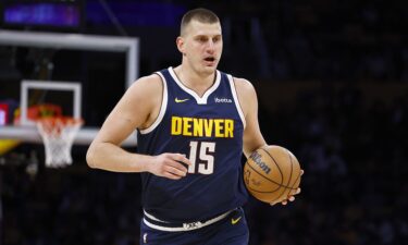 Jokić looks to pass in the NBA preseason game between the Nuggets and the Celtics.