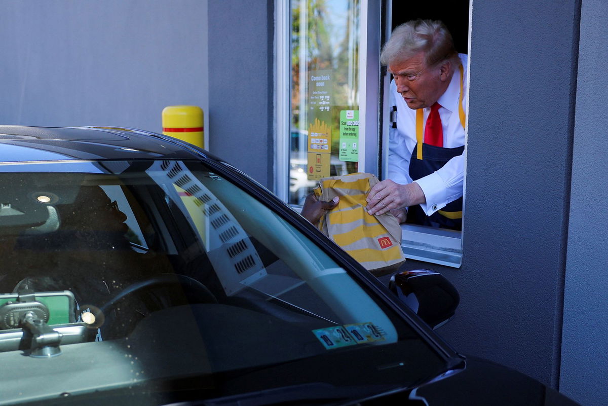 <i>Brian Snyder/Reuters via CNN Newsource</i><br/>Former President Donald Trump serves food at a McDonalds restaurant in Pennsylvania.