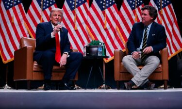 Former President Donald Trump sits down with Tucker Carlson during his Live Tour at the Desert Diamond Arena on October 31