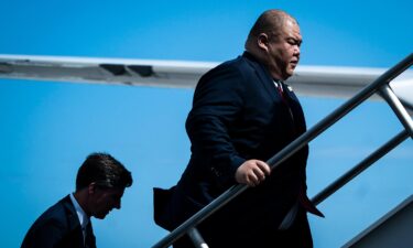 Steven Cheung follows former President Donald Trump as they board his plane to fly back to New Jersey on June 13 in Miami.