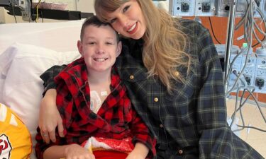 (From left) Children's Mercy Hospital patient Beckett Thomas and Taylor Swift -- wearing the same outfit she gifted Naya Jade (not pictured) -- at Children's Mercy Hospital in Kansas City on December 12.