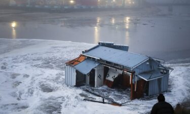 People look at a portion of the collapsed pier at the Santa Cruz Wharf in Santa Cruz