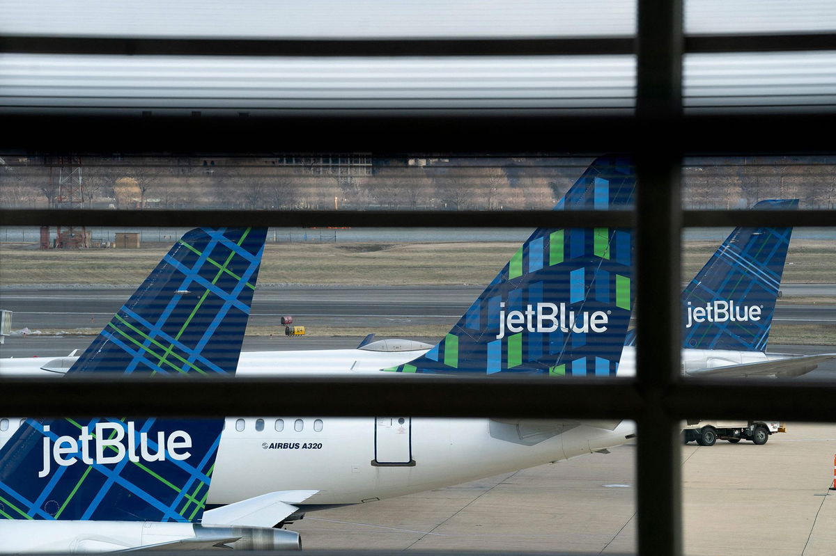 <i>Stefani Reynolds/AFP/Getty Images via CNN Newsource</i><br/>JetBlue planes sit at Ronald Reagan Washington National Airport in Arlington