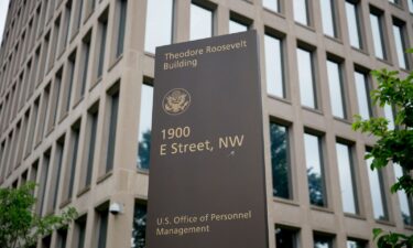 A sign stands outside of the Theodore Roosevelt Building