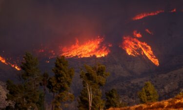 The smoke and flames of the Hughes Fire are seen near Castaic Lake