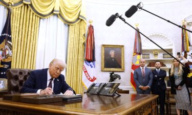 President Donald Trump signs a series of executive orders in the Oval Office of the White House on Thursday