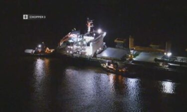 Multiple small boats were working to dislodge a cargo ship that became stuck in the Delaware River near Philadelphia.