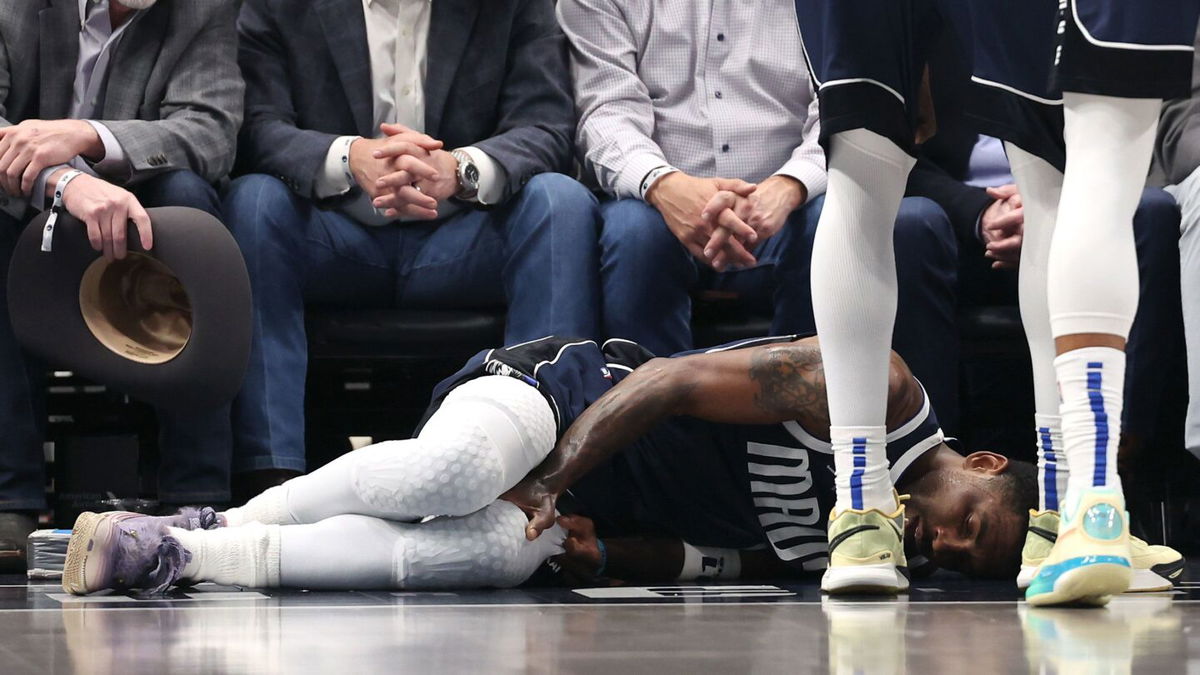 <i>Sam Hodde/Getty Images via CNN Newsource</i><br/>Kyrie Irving lies on the court after suffering an injury against the Sacramento Kings on March 3.