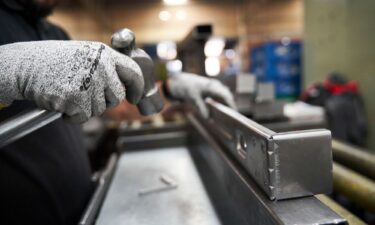 A worker inspects aluminum parts at an auto parts manufacturer in San Luis Potosi