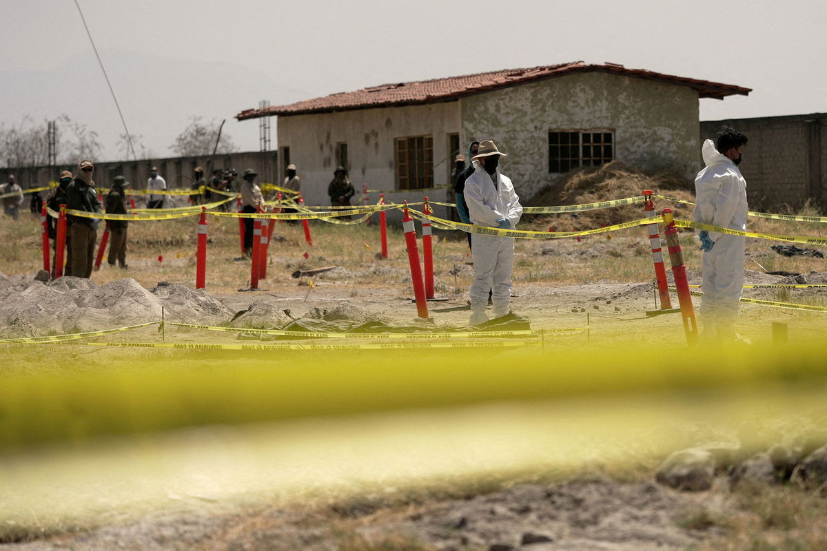 <i>Ivan Arias/Reuters via CNN Newsource</i><br/>Forensic technicians stand at a cordoned area during a media tour by Jalisco's Attorney General Office at Izaguirre Ranch in March. Activists have called the property a cartel-run "extermination camp."