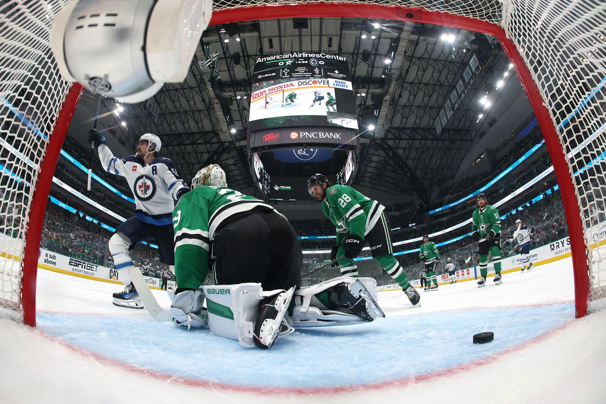 <i>Gareth Patterson/AP via CNN Newsource</i><br/>Dallas Stars' Sam Steel is tripped by Winnipeg Jets' Mark Scheifele as Steel chases after the puck with seconds left in regulation time.
