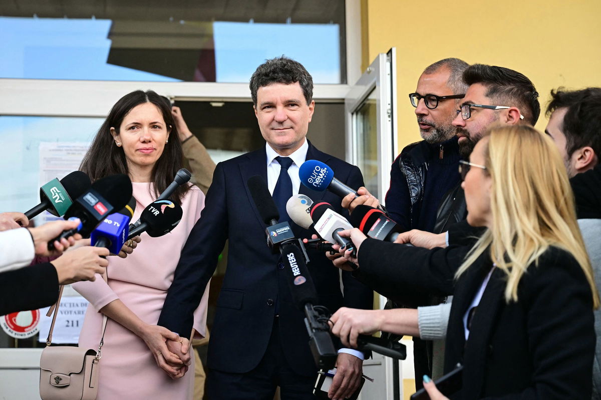 <i>Daniel Mihailescu/AFP/Getty Images via CNN Newsource</i><br/>Bucharest Mayor and independent presidential candidate Nicusor Dan and his wife Mirabela Gradinaru are seen after voting at a polling station in Fagaras