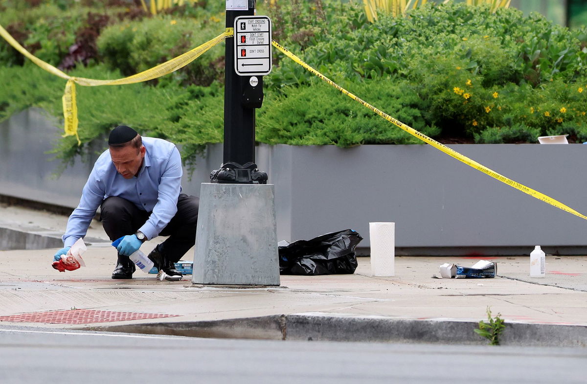 <i>Jonathan Ernst/Reuters via CNN Newsource</i><br/>Police officers work at the site where