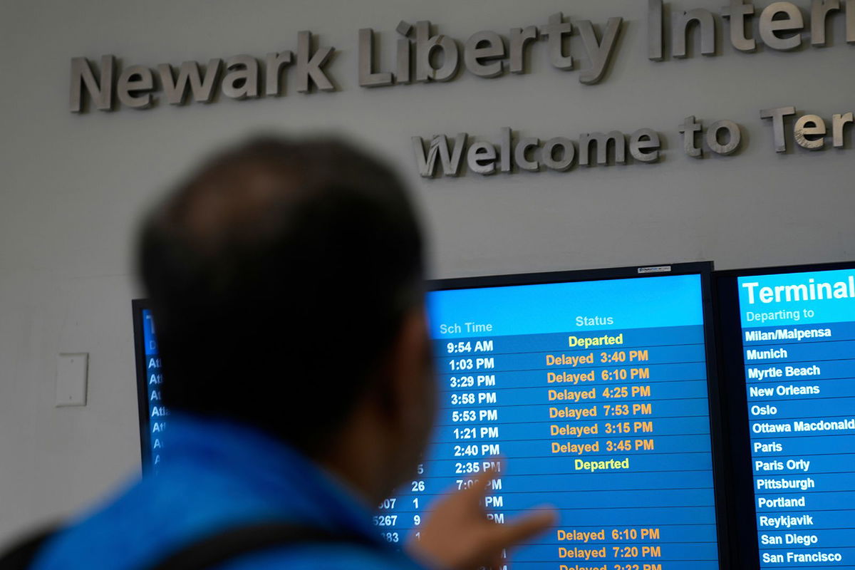 <i>Seth Wenig/AP via CNN Newsource</i><br/>A display shows the status of flights at Newark Liberty International Airport in Newark