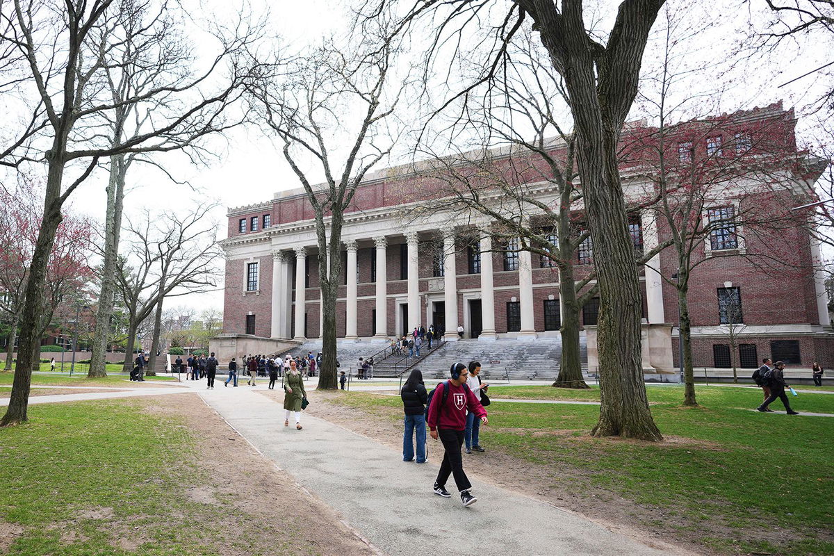 <i>Charles Krupa/AP via CNN Newsource</i><br/>Pedestrians walk in April past the Widener Library at Harvard University in Cambridge