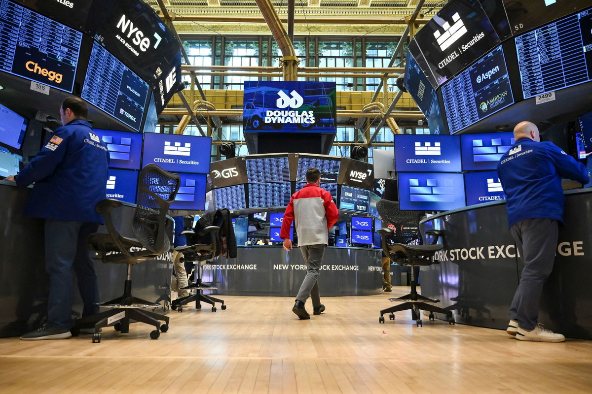 <i>Angela Weiss/AFP/Getty Images via CNN Newsource</i><br/>Traders work on the floor of the New York Stock Exchange. US stocks were mixed on May 13 as investors digested cooling inflation data and easing trade tensions between the United States and China.