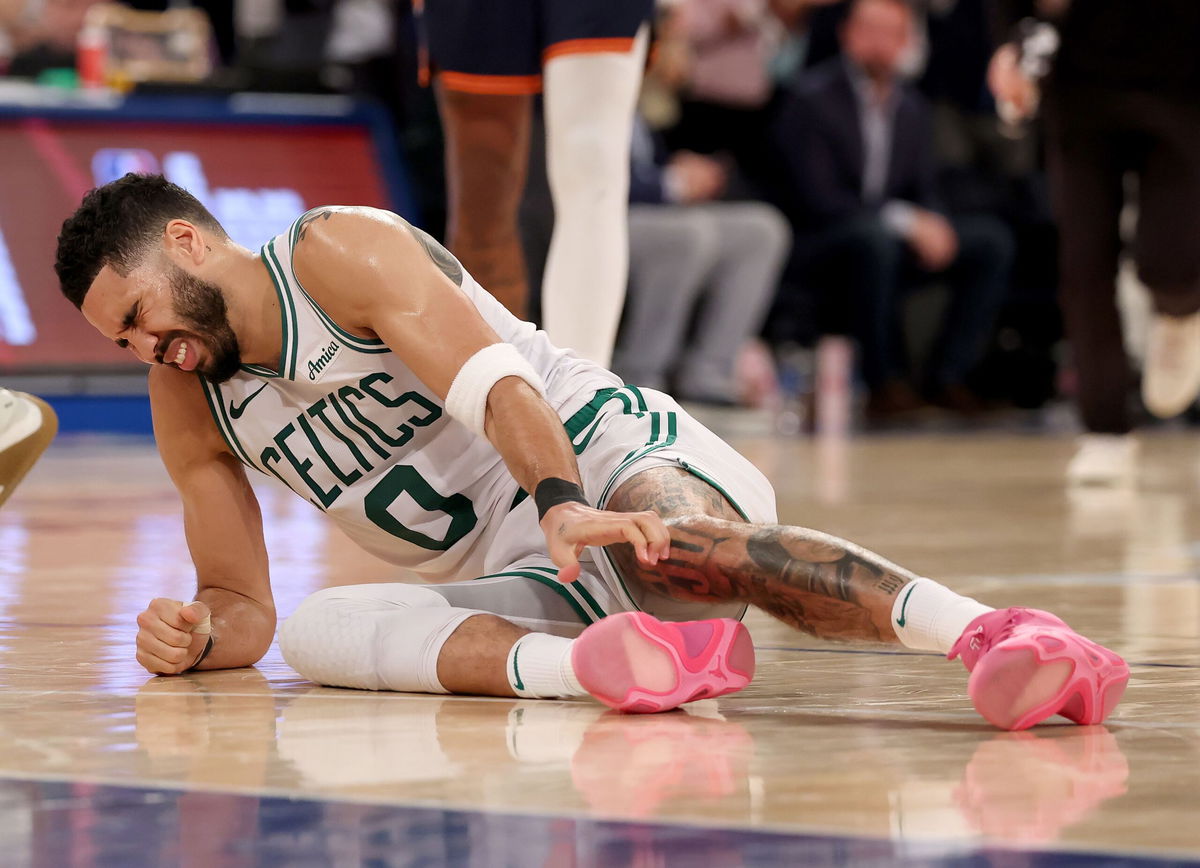 <i>Elsa/Getty Images North America/Getty Images via CNN Newsource</i><br/>Jayson Tatum of the Boston Celtics lays on the ground after being injured against the New York Knicks during the fourth quarter on May 12. Tatum ruptured his right Achilles tendon in Monday night’s playoff game.