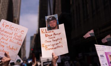 A person holds a sign with a photo of Kilmar Abrego Garcia as people take part in a protest organised to 'Protect Migrants