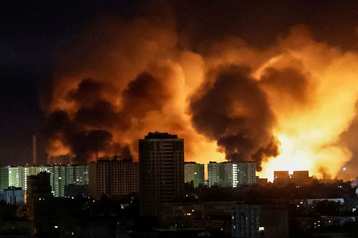 <i>Gleb Garanich/Reuters via CNN Newsource</i><br/>An explosion lights up the sky over Kyiv during a Russian drone strike on Saturday.
