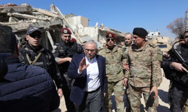 Lebanon's Prime Minister Nawaf Salam walks among Lebenese army soldiers as he visits the sourthern village of Khiam near the border with Israel