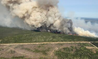 Smoke rises from a wildfire near Wanless