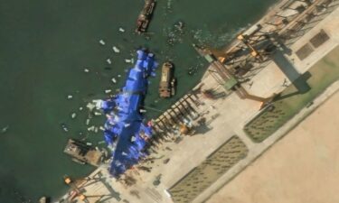 A satellite image shows what appear to be white balloons floating above the stranded North Korean warship that was damaged after a failed launch