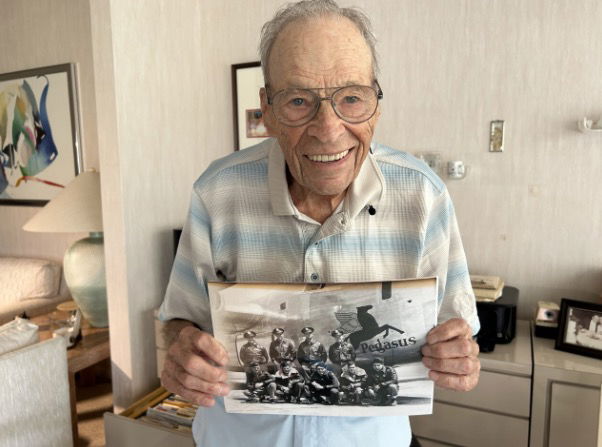 <i>WPTV via CNN Newsource</i><br/>World War Two Veteran Sydney Edson holds a picture of his bomb Squadron crew.