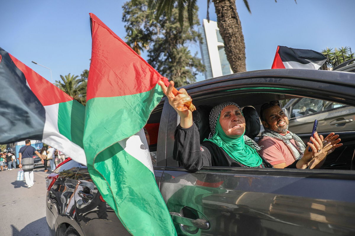 <i>Chedly Ben Ibrahim/NurPhoto/Shutterstock via CNN Newsource</i><br/>Pro-Palestinian activists wave Palestinian flags from open car windows as they depart from Tunis