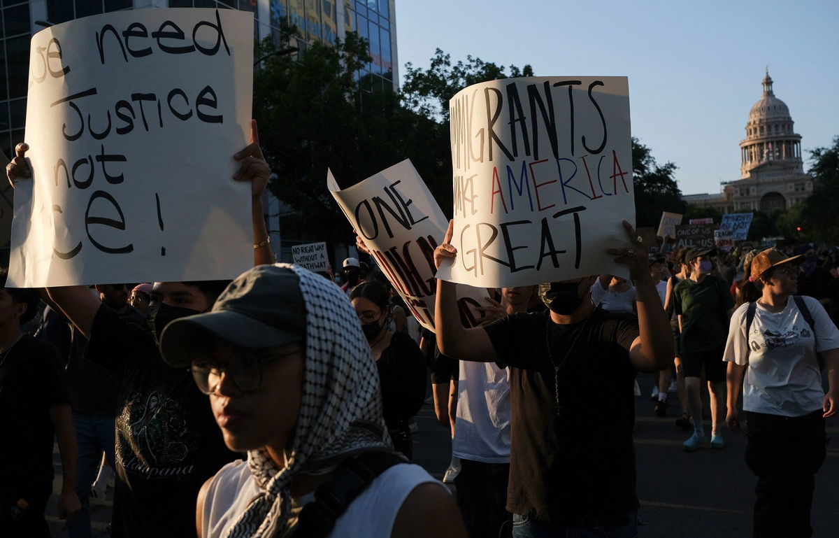 <i>Joel Angel Juarez/Reuters via CNN Newsource</i><br/>Demonstrators hold signs Monday during a rally in Austin