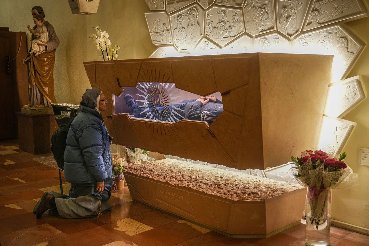 <i>Christopher Furlong/Getty Images via CNN Newsource</i><br/>A nun prays at the tomb of Carlo Acutis in the Church of Santa Maria Maggiore in Assisi