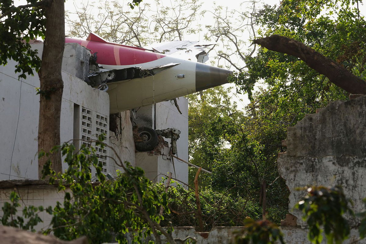 <i>Sam Panthaky/AFP/Getty Images via CNN Newsource</i><br/>A firefighter works at the site where Air India flight 171 crashed in a residential area near the airport in Ahmedabad on June 12