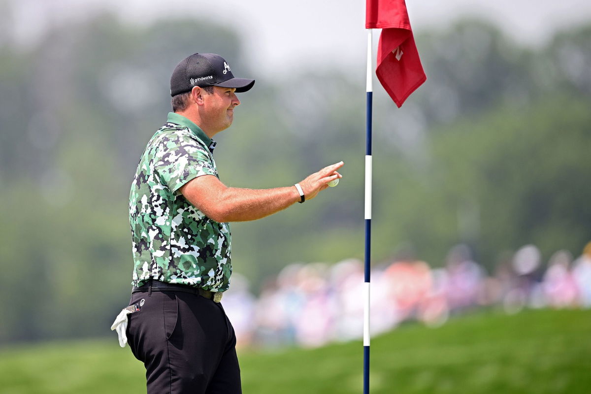 <i>Ross Kinnaird/Getty Images via CNN Newsource</i><br/>Patrick Reed picks up his ball after carding an albatross on the par-5 fourth at Oakmont Country Club.