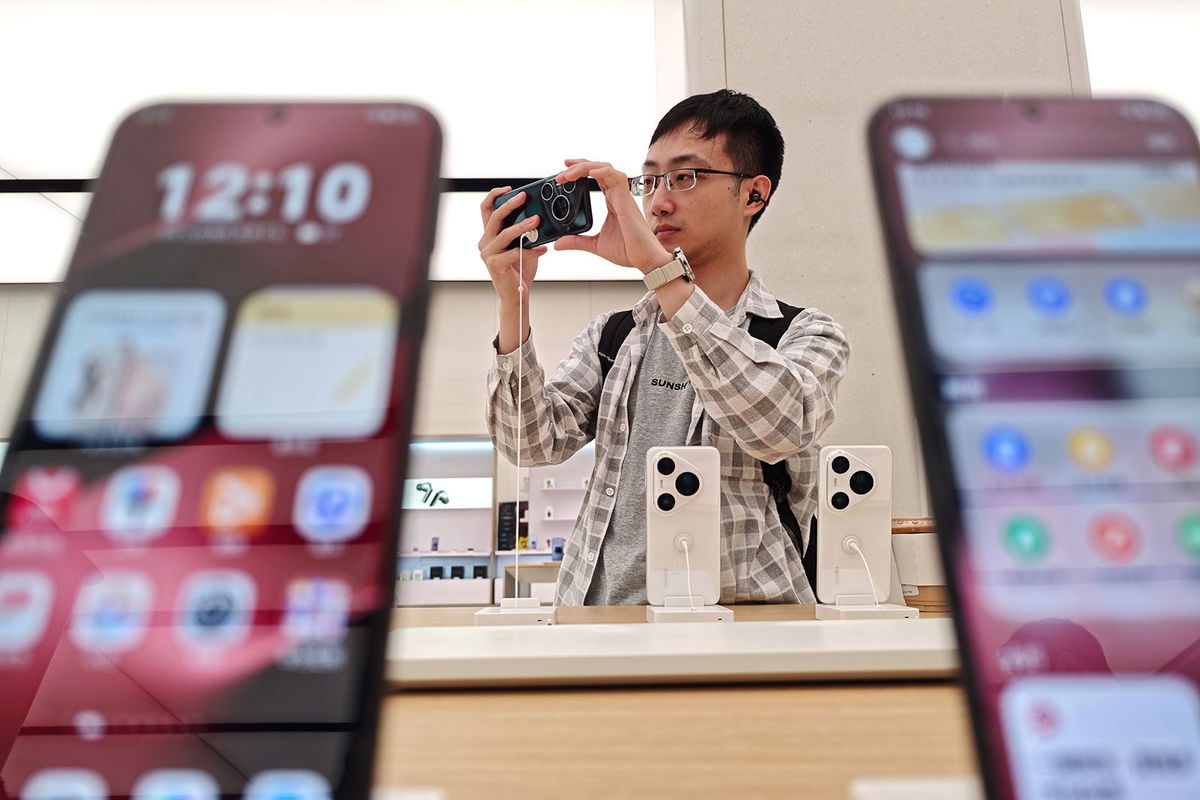 <i>NurPhoto/Getty Images via CNN Newsource</i><br/>A customer tries a new Huawei phone in the company's flagship store in Shanghai