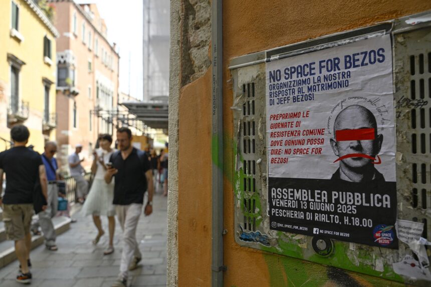 Protesters display a banner reading "No Space for Bezos!" on the Rialto Bridge.