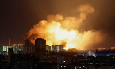 A resident stands near buildings damaged by Russian military strikes in the front line town of Myrnohrad