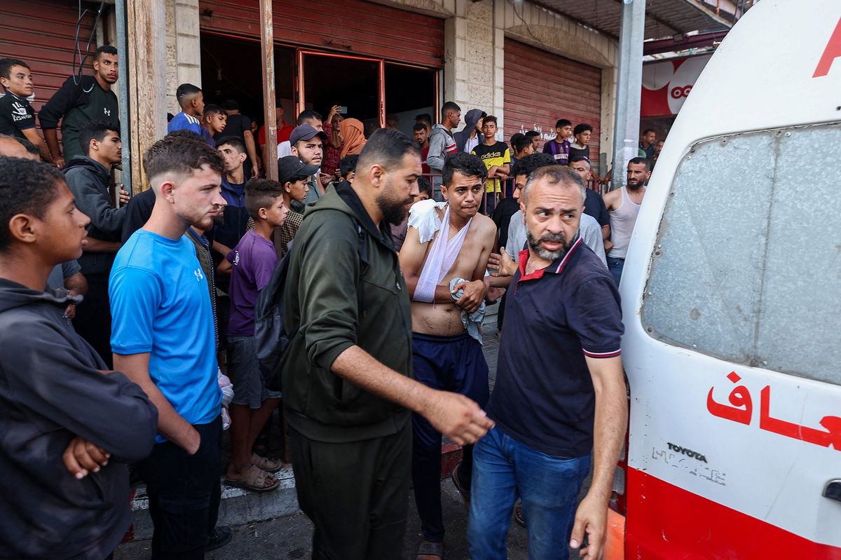 <i>Abdel Kareem Hana/AP via CNN Newsource</i><br/>Palestinians carry food packages from the US and Israeli-backed Gaza Humanitarian Foundation