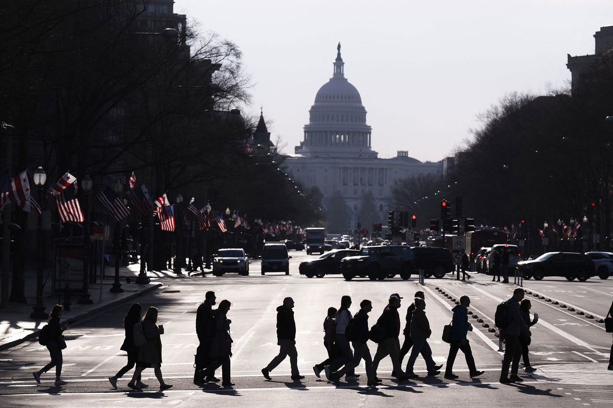<i>Roberto Schmidt/AFP/Getty Images via CNN Newsource</i><br/>Commuters cross Pennsylvania Avenue in Washington