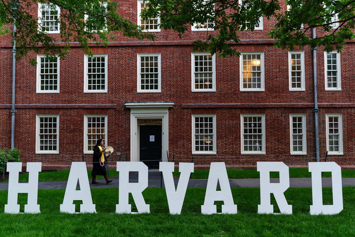 <i>Sophie Park/Bloomberg/Getty Images via CNN Newsource</i><br/>A students walks past a display on the Harvard University campus in Cambridge